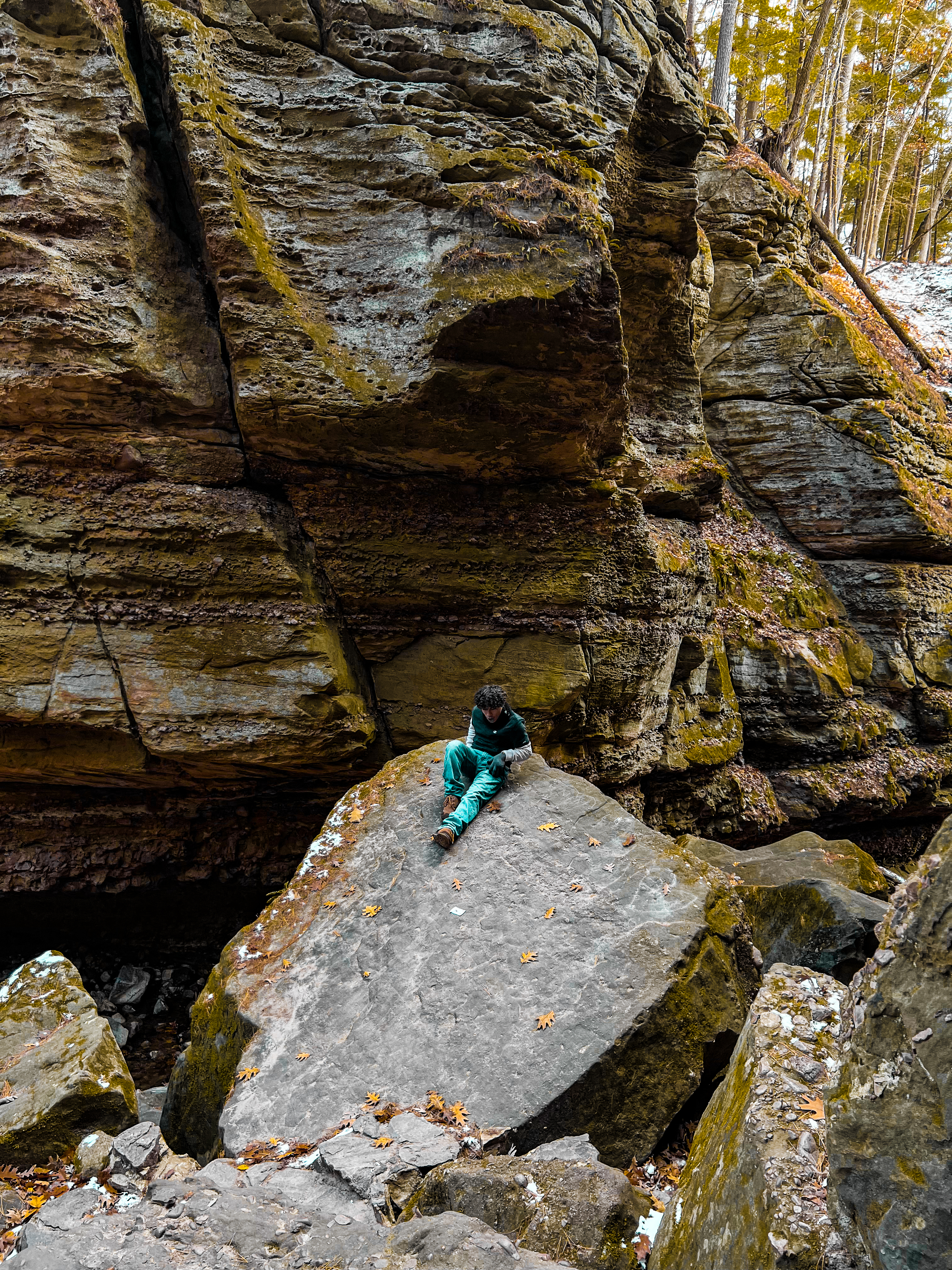 Person seated on a large rock at Parfrey's Glen
